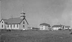 Roman Catholic Mission church, residence, school and hospital in rear July 1941