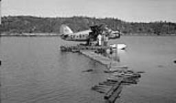Canadian Pacific Airlines Norseman aeroplane on Bigspruce Lake, wharf of construction crew 1946