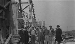 Hon. J.A. Glen and party at headframe No. 2 shaft, Giant Yellowknife Gold Mines Ltd August 1946.