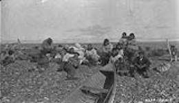 [R.T. Porsild with Inuvialuit men at Tuktoyaktuk, east of Kittigazuit] Original title: Natives at tutuayaktoq east of Kittigazuit August 1927