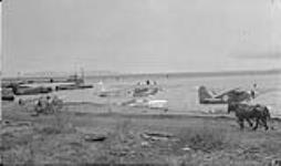 Group of civil & military aircraft, Port Arthur, Ont. Taken 1933-39. L to R: Fokker 'Super Universal' aircraft CF-AFS, Hamilton H-47 'Metalplane' aircraft CF-OAH of the Ontario Provincial Air Service, Bellanca CH-300 'Pacemaker 1933-1939