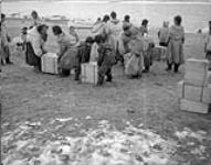 [Inuit families helping to unload supplies] Original title: Eskimo families helping to unload supplies 1944