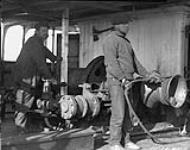 Poitras (Carpenter) and Leblanc (Quartermaster) working winch on C.G.S. "Arctic" 1924