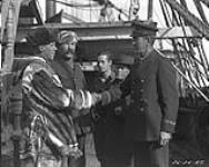 Inspector Wilcox welcomed on board "Arctic" by F.D. Henderson, 2nd officer Lemieux, and R.S. Finnie 1924