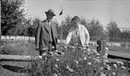 Mr. and Mrs. J.A. McDougall with poppies 1930