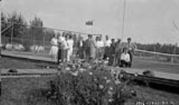 Group fo Tennis players on tennis court. Fort Smith Government residence 1930