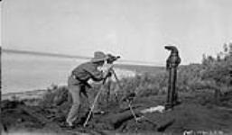 R.S. Finnie shooting the oil well at Fort Norman 1930