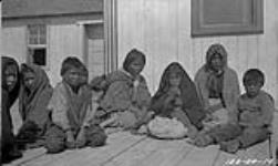 [Tlicho man, woman and children at the Roman Catholic Mission] Original title: Indians (Dog-Rib) R.C. Mission 1924
