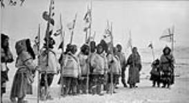 [Tasiujaq Inuit with flags] Original Title: Leaf River Eskimos with flags 5 May 1931.