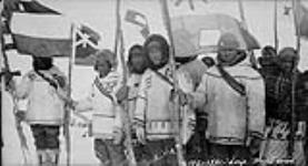 [Tasiujaq Inuit with flags] Original Title: Leaf River Eskimos with flags 1931.