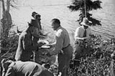 Leigh Brintnell serving Lord Tweedsmuir his steak [at Eldorado Mine, Great Bear Lake] June 1937.