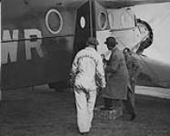 Lord Tweedsmuir (centre) boarding a Bellanca 66-70 'Aircruiser' of Mackenzie Air Service Ltd. James Bell at right June 1937.