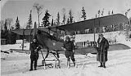 Mr. W. L. Brintnell [left] and associates with DH60X 'Moth' aircraft G-CAIG of Western Canada Airways December, 1927.