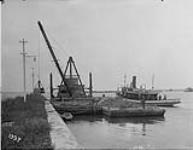Soulanges Canal Derrick, three scows, tug "Dandy" from protection pier Aug. 29, 1921
