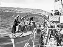 Infantrymen of the 1st Battalion, The Black Watch (Royal Highland Regiment) of Canada, disembarking from H.M.C.S. OTTAWA, Botwood, Newfoundland, 22 June 1940 June 22, 1940.