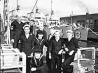 Group of U.S. Navy and Royal Navy ratings who took part in the transfer of destroyers to the Royal Navy and Royal Canadian Navy, Halifax, Nova Scotia, Canada, ca. 23-24 September 1940 [ca. September 23-24, 1940].