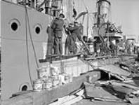 Unidentified naval ratings painting the destroyer H.M.C.S. RESTIGOUCHE, Halifax, Nova Scotia, Canada, October 1940 October 1940.
