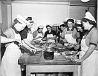 Personnel of the Women's Royal Canadian Naval Service (W.R.C.N.S.) working in the galley of H.M.C.S. KINGS, Halifax, Nova Scotia, Canada, 3 March 1943 March 3, 1943.