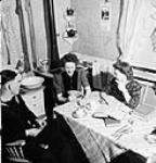 Female students of the University of Alberta entertaining a friend in the converted garage which is their boarding house Mar. 1944