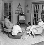 The Schiefner farm near Milestone, Sask. The Schiefner family watches television, Dec. 1956 Dec. 1956