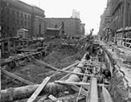 Excavating on Front Street between York and Bay Streets for Construction of the Toronto Rapid Transit Subway. Feb. 1950 n.d.