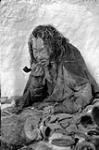 Starving Padleimiut woman [Hiutiruq] at camp on South Honik Lake Feb. 1950.