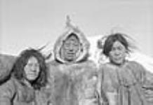 [Aryaut (center) and his wives,  Kablu (left) Paniukaq (right).] s.d.