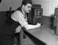 Jack Marsters with horizontal enlarger in Montreal Gazette darkroom 9-15 Apr. 1939