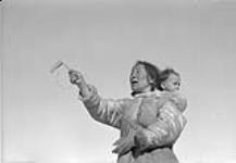 Inuit woman playing a string game 1951.