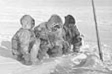 [(Left to right): Nutarasungnik, Ukanaaq, and unidentified individual ice fishing.] [1949-50]