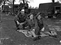 Lance-Corporal A.W. Hartung with Pipers Flossie Rose (centre) and Mona Michie of the Canadian Women's Army Corps (C.W.A.C.) Pipe Band, Zeist, Netherlands, 25 August 1945 August 25, 1945.