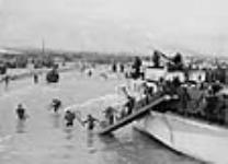Troops of the Nova Scotia Highlanders and the Highland Light Infantry of Canada landing at Bernières-sur-Mer, 6 June 1944. Disembarking from L.C.I. of the Canadian Landing Craft Infantry (Large) Flotilla, of either the 260th, 262nd, or 264th 6 June 1944