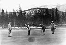 Golfers playing on unidentified golf course ca. 1920's