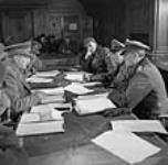 Lieutenant-General Charles Foulkes (left) faces General Reichilt (right) during a conference on the surrender of German forces in the Netherlands 5 May 1945