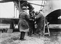 Capt. John Alcock (centre) during loading of Vickers "Vimy" aircraft prior to trans-Atlantic flight, Lester's Field 1919