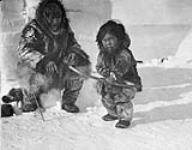 Man with boy (probably Allakariallak/Nanook and Phillipoosie) 1920-1921.