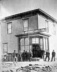 À l'intersection de la 8th Street et de l'avenue Rosser, mai 1882(Brandon, Territoires du Nord-Ouest, Apothecaries' Hall, A. Fleming, apothicaire) May 1882