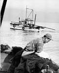 [Ken Tanaka fishing for shrimp off Vancouver, B.C.] [c.a. 1951]