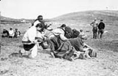 Inuit women's boot race on Sports Day, Wakeham Bay, N.W.T. [Nunavut], ca. June or July 1928 [ca. June or July 1928].