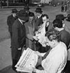 Citizens reading newspaper headlines concerning [Newfoundland's] confederation with Canada sept. 1949
