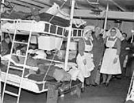 Nursing sisters and patients in a ward aboard No.2 Canadian General Hospital Ship LETITIA, Liverpool, England, 24 November 1944 November 24, 1944.
