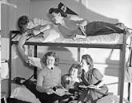 Personnel of the Women's Royal Canadian Naval Service (W.R.C.N.S.) in a dormitory, Halifax, Nova Scotia, Canada, May 1943 May 1943.