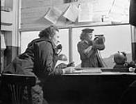 Signallers Marian Wingate and Margaret Little of the Women's Royal Canadian Naval Service at work April 1945.