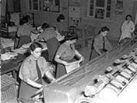 Personnel of the Canadian Women's Army Corps (C.W.A.C.) operating pressing machines at the Surrey County Council Central Laundry, Carshalton, England, 19 August 1943 August 19, 1943.