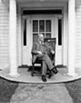 W.L. Mackenzie King, former Prime Minister of Canada, seated in a chair presented to him at Tyree, Scotland, in 1937. This is the last photograph of Mr. King at Kingsmere 18-Jul-50