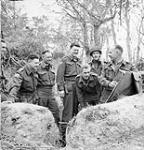 Lieutenant-Colonel P.C. Klaehn (centre), Commanding Officer of The Cameron Highlanders of Ottawa (M.G.), holding a map session with officers of the regiment near Caen, France, 15 July 1944 July 15, 1944.