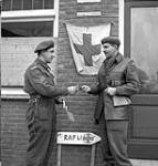 Lieutenant-Colonel Julien Bibeau, Commanding Officer, presenting Corporal Lucien Nantel of Le Régiment de Maisonneuve with the Military Medal, Ossendrecht, Netherlands, 17 October 1944 October 17, 1944.