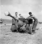 Infantrymen of The Highland Light Infantry of Canada attaching drag ropes to a six-pounder anti-tank gun, Thaon, France, 6 August 1944 August 6, 1944.