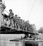 Lieutenant-Colonel Charles Petch, Commanding Officer, leading The North Nova Scotia Highlanders across London Bridge, a Bailey bridge across the Odon River south of Caen, France, 18 July 1944 July 18, 1944.