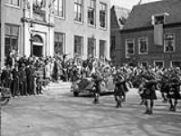 Pipe bands of The Highland Light Infantry of Canada and The North Nova Scotia Highlanders arriving at a civic reception, Leeuwarden, Netherlands, 16 April 1945 April 16, 1945.